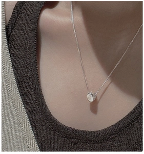 Minimalist S925 sterling silver necklace featuring a polished triangle pendant on a model