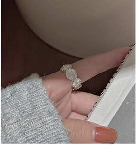 Macro view of S925 silver ring featuring star-embossed oval charms and hammered texture
