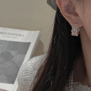 Elegant S925 sterling silver earrings with vintage lace texture on a female model