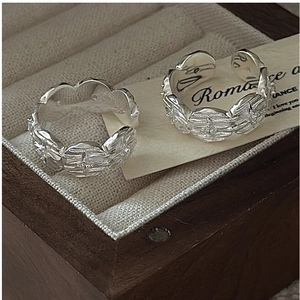 Detail showing vintage S925 silver star pattern rings on a velvet jewelry box