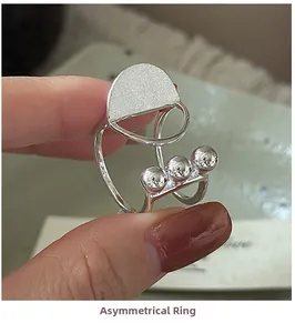 Close-up of S925 silver ring featuring brushed finish beads and irregular geometric design