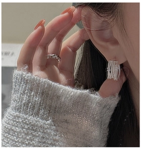 Close-up of elegant S925 sterling silver crisscross earrings with sparkling zircons