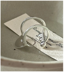 Detail of S925 sterling silver double-layer ring with three inlaid clear zircons