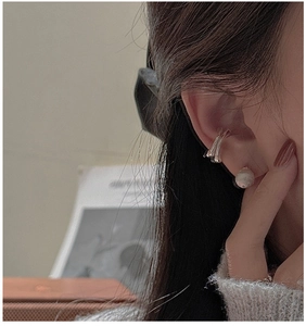Close-up of S925 silver layered ear cuff and round pearl stud on a female ear