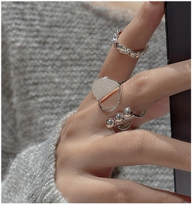 Close-up of S925 sterling silver ring set featuring brushed beads and wavy textured bands