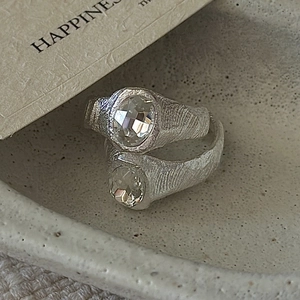 Minimalist S925 silver textured rings set with oval zircon gemstones on beige tray