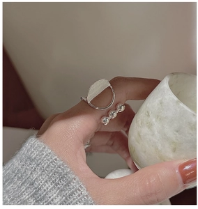 Close-up of S925 sterling silver geometric ring with brushed metal and polished beads