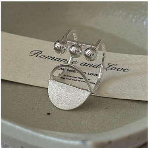 Detail of S925 sterling silver ring with polished beads and frosted geometric disc