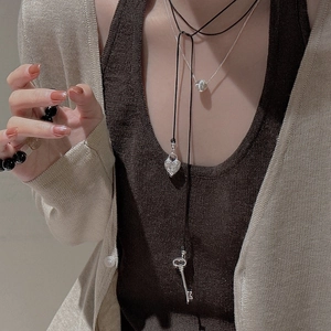 Collier multicouche en argent S925 avec cœur et clé porté par un modèle style rétro