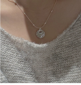 Detail of S925 sterling silver hammered texture pendant on a beaded link chain necklace