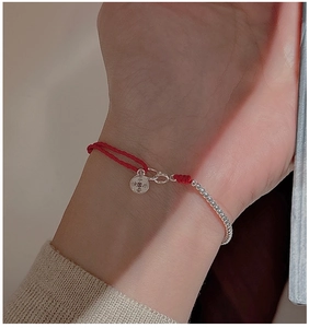 Detailed shot of S925 silver red string bracelet with engraved blessing pendant