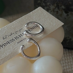 Minimalist S925 sterling silver ear cuffs with fluid liquid metal design on white paper