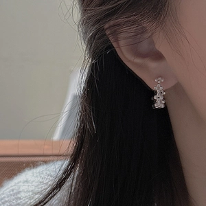 Boucles d'oreilles élégantes en argent 925 avec perles portées par un mannequin de près