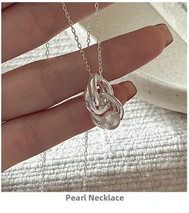Macro detail of S925 sterling silver chain featuring an elegant pearl pendant design