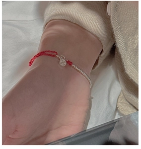 Close-up of S925 sterling silver beads and red woven rope bracelet with snowflake charm