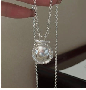 Detail of S925 sterling silver necklace with handcrafted hammered texture round pendant