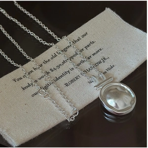 Macro shot of S925 sterling silver necklace with minimalist irregular round pendant