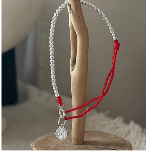 Detail of S925 sterling silver beads and red woven cord with Happy engraving charm