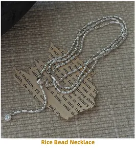 Detail of silver olive bead necklace with sparkling zirconia pendant on vintage background