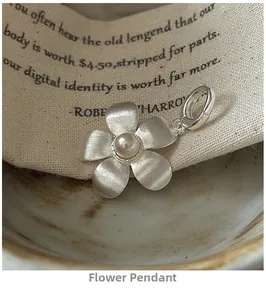 Macro shot of S925 sterling silver flower pendant with brushed texture and pearl