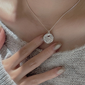 S925 sterling silver minimalist necklace with textured round pendant on gray sweater