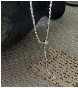 Detail of adjustable S925 sterling silver Y-shaped necklace with olive beads and zircon drop