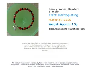 Detail view of S925 silver beaded bracelet with red agate stones and leaf charm