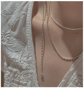 Close-up of S925 sterling silver layered necklace with round pendant and zircon stones