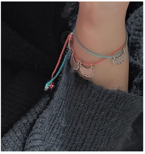 Detail of S925 silver woven rope bracelet with crescent moon charms on wrist