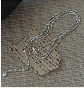 Close-up of S925 sterling silver olive bead chain necklace with a small crystal pendant
