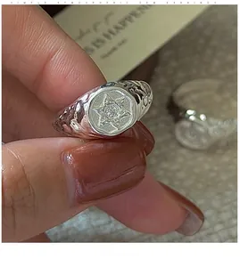 Detailed macro of vintage silver ring with engraved hexagram star and zircon inlay