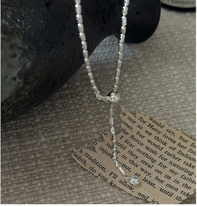 Close-up of S925 silver slider clasp and delicate olive bead chain with zircon detail
