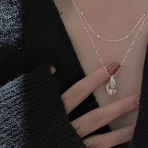 Double-layered S925 silver necklace with elegant pearl pendant on black sweater