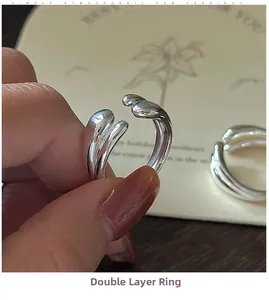 Macro shot of minimalist S925 silver double layer crossover ring with adjustable band