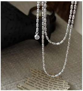 Detail of S925 sterling silver cylinder chain with a sparkling clear zircon pendant