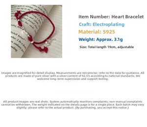 Detail view of S925 sterling silver heart lock pendant on a braided red rope bracelet