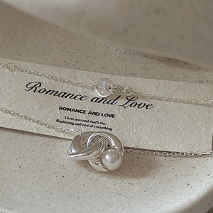 S925 sterling silver necklace featuring a unique metal knot design with a white pearl