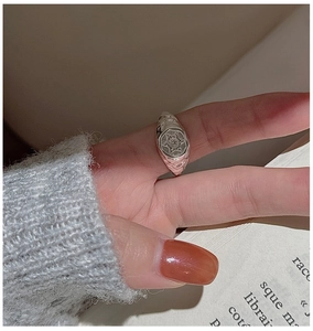 Close-up of retro S925 sterling silver signet ring with star engraving and hammered texture