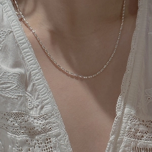 Minimalist S925 sterling silver olive bead necklace on a neck with lace background