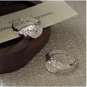 Detail of S925 sterling silver hexagon rings with hammered texture and star engraving