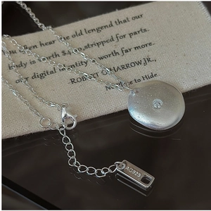 Macro shot of 925 sterling silver necklace with zircon pendant and AG925 hallmark tag