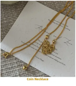 Detail of vintage gold-plated necklace with copper coin pendant and heart charm on card
