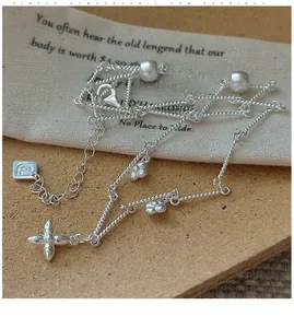 Macro shot of S925 sterling silver twisted chain necklace with clover flower and silver beads