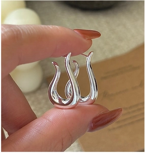 Close-up of polished S925 sterling silver curved hook earrings with minimalist design