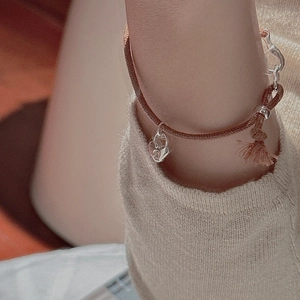 S925 sterling silver woven heart lock bracelet with brown rope and tassels on wrist