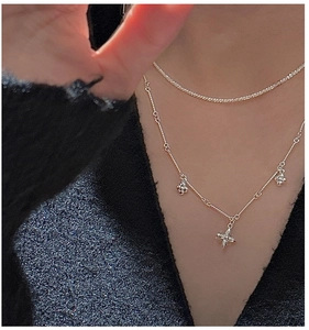 Close-up of S925 sterling silver layered necklace with flower pendants and sparkling rhinestones
