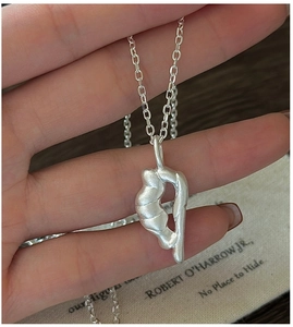 Macro shot of silver abstract S925 sterling silver necklace with matte fluid pendant