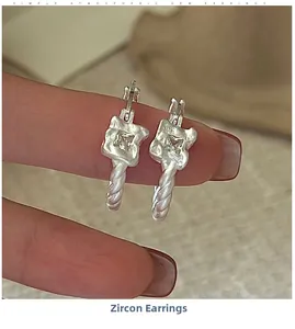 Close-up of S925 silver twist hoop earrings with square zircon held by hand