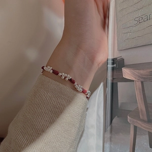 Handcrafted S925 sterling silver beads woven red rope bracelet worn on a female wrist