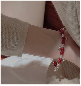 Detail of S925 sterling silver beaded bracelet with red agate beads and silver bells